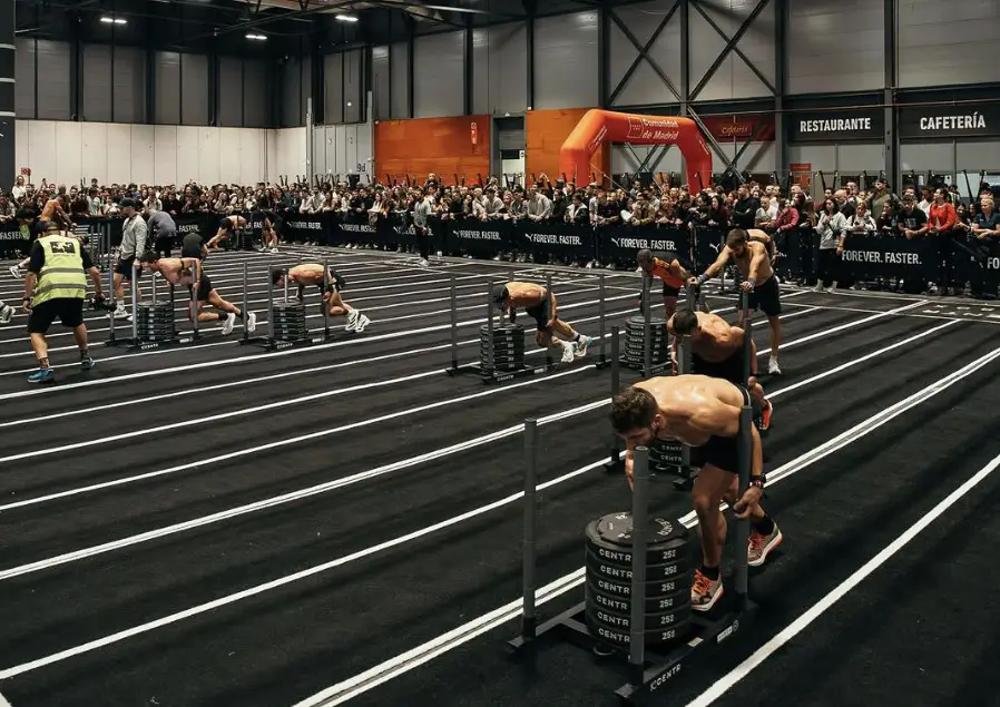 Composición visual de entrenamiento híbrido en OpenGym.es mostrando un atleta realizando sentadillas de fuerza y carrera de resistencia.